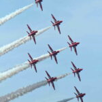 The Red Arrows captured mid-formation, precision and symmetry against a blue sky.